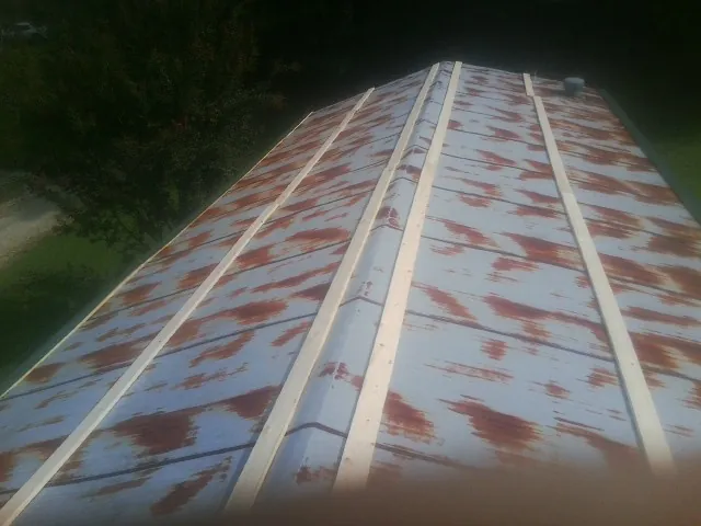 Rusted metal roof panels with new wood purlins before replacement — Storm Damage Roof Repair in Napanoch by Roofing Brothers